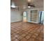 Large living area with terracotta floors and ceiling fan at 144 Garden Ln, Sarasota, FL 34242