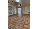 Spacious living room with terracotta tile floors and built-in shelving at 144 Garden Ln, Sarasota, FL 34242