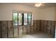 Unfinished room with exposed cinder block walls and tile flooring at 144 Garden Ln, Sarasota, FL 34242