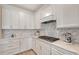 Stylish kitchen with white cabinets, marble backsplash, and gas cooktop at 18122 Harwich Pl, Bradenton, FL 34202
