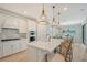 Bright kitchen with white cabinets, quartz countertops, and gold fixtures at 18122 Harwich Pl, Bradenton, FL 34202