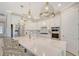 Modern kitchen featuring white cabinets, a large island, and gold fixtures at 18122 Harwich Pl, Bradenton, FL 34202