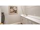 Laundry room with sink, cabinets, and a framed floral print at 18122 Harwich Pl, Bradenton, FL 34202