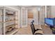 Home office with wood desk and open french doors at 18122 Harwich Pl, Bradenton, FL 34202