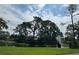 Aerial view of a peaceful community with lush landscaping and a pond at 3711 Pinecone Ct # 168, Sarasota, FL 34238