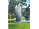 Modern fountain feature in a landscaped area with a pond at 3711 Pinecone Ct # 168, Sarasota, FL 34238