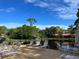 Community pool deck with numerous lounge chairs and lake view at 3711 Pinecone Ct # 168, Sarasota, FL 34238