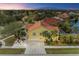 Aerial view of two story house with tile roof, two car garage, and landscaped yard at 2501 Broad St, Nokomis, FL 34275