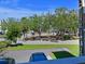 View from balcony showing lush green landscaping and parking lot at 4480 Ironwood Cir # 202A, Bradenton, FL 34209