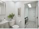 Clean bathroom with toilet, sink, and laundry access at 5296 White Sand Ne Cir, St Petersburg, FL 33703