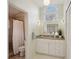 Bright bathroom boasts a vanity with granite countertop, shower, and toilet at 5296 White Sand Ne Cir, St Petersburg, FL 33703