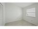 Simple bedroom with window, closet, and light flooring at 5296 White Sand Ne Cir, St Petersburg, FL 33703