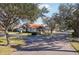 Home's exterior, showcasing a red tile roof and lush landscaping at 5296 White Sand Ne Cir, St Petersburg, FL 33703