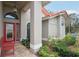 Inviting front entry with a red door and a red bench at 5296 White Sand Ne Cir, St Petersburg, FL 33703