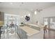 Modern kitchen with a large island and view into dining area at 5296 White Sand Ne Cir, St Petersburg, FL 33703