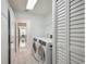 Bright laundry room features washer, dryer, and built-in storage at 5296 White Sand Ne Cir, St Petersburg, FL 33703