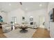 Light and airy living room with hardwood floors, sofa, and armchairs at 5296 White Sand Ne Cir, St Petersburg, FL 33703