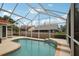 Inviting kidney-shaped pool with screened enclosure at 5296 White Sand Ne Cir, St Petersburg, FL 33703