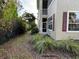 Small, private backyard with grass and shrubs beside the townhome at 7937 St Simons St # 7937, University Park, FL 34201