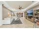 Open living room with white sectional and view of kitchen and entertainment center at 12046 Forest Park Cir, Bradenton, FL 34211