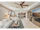 Open living room with white sectional and view of the pool at 12046 Forest Park Cir, Bradenton, FL 34211