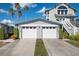 Exterior view of the property showcasing the two car garage and the well maintained yard at 1291 Siesta Bayside Dr # 1291A, Sarasota, FL 34242