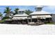 Beachfront bar with umbrellas and seating at 114 31St St, Holmes Beach, FL 34217