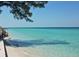 Steps lead down to a pristine, calm beach at 114 31St St, Holmes Beach, FL 34217