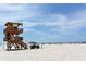 Lifeguard stand and beach with people enjoying the sun at 114 31St St, Holmes Beach, FL 34217