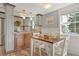 Modern kitchen with two-toned cabinets and a farmhouse dining table at 114 31St St, Holmes Beach, FL 34217