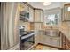 Modern kitchen with stainless steel farm sink and granite countertops at 114 31St St, Holmes Beach, FL 34217