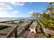 Relaxing waterfront deck with benches and tables, offering scenic views at 1717 Pelican Cove Rd # 334, Sarasota, FL 34231