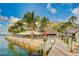 Outdoor waterfront restaurant with palm trees and thatched roofs at 33 S Gulfstream Ave # 307, Sarasota, FL 34236