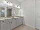 Double vanity bathroom with grey cabinets and quartz countertop at 4950 Kiva Cir, Bradenton, FL 34211