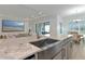 Kitchen boasts a large island with granite countertops and sink at 4950 Kiva Cir, Bradenton, FL 34211