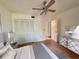 Bright bedroom with a ceiling fan, closet, neutral decor, and wood-look floors at 6447 Egret Ln # 413, Bradenton, FL 34210