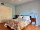 The bedroom offers a light blue walls, wood floors and double closet doors at 6447 Egret Ln # 413, Bradenton, FL 34210