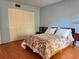 The bedroom offers a light blue walls, wood floors and double closet doors at 6447 Egret Ln # 413, Bradenton, FL 34210