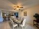 Charming dining room features a table set for six, a ceiling fan, and seamless access to the kitchen at 6447 Egret Ln # 413, Bradenton, FL 34210