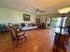 Comfortable living room with wood-look floors, ceiling fan, and sliding glass doors to screened lanai at 6447 Egret Ln # 413, Bradenton, FL 34210