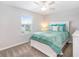 Well-lit bedroom with a queen bed, window, and ceiling fan at 9095 Rally Spring Loop, Wesley Chapel, FL 33545