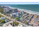 Aerial view of beachfront condo building with ocean and tennis court views at 1102 Benjamin Franklin Dr # 409, Sarasota, FL 34236