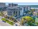 Beautiful beachfront condo building with a tennis court, lush landscaping, and ample parking near the beach at 1102 Benjamin Franklin Dr # 409, Sarasota, FL 34236