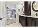 Double vanity bathroom with dark wood cabinets and view of bedroom at 117 Hillcrest Dr, Bradenton, FL 34209