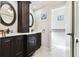 Elegant bathroom with double vanity, large mirrors, and a separate toilet area at 117 Hillcrest Dr, Bradenton, FL 34209