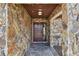 Stone-walled entryway with a dark wood front door at 117 Hillcrest Dr, Bradenton, FL 34209