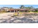 House exterior with a stone facade and a manicured lawn at 117 Hillcrest Dr, Bradenton, FL 34209