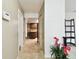 Hallway with tile flooring, leading to kitchen and closets at 117 Hillcrest Dr, Bradenton, FL 34209