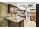 Eat-in kitchen with granite countertops and wood cabinets at 117 Hillcrest Dr, Bradenton, FL 34209