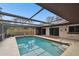 Inviting screened pool area with patio and sliding glass doors to interior at 117 Hillcrest Dr, Bradenton, FL 34209